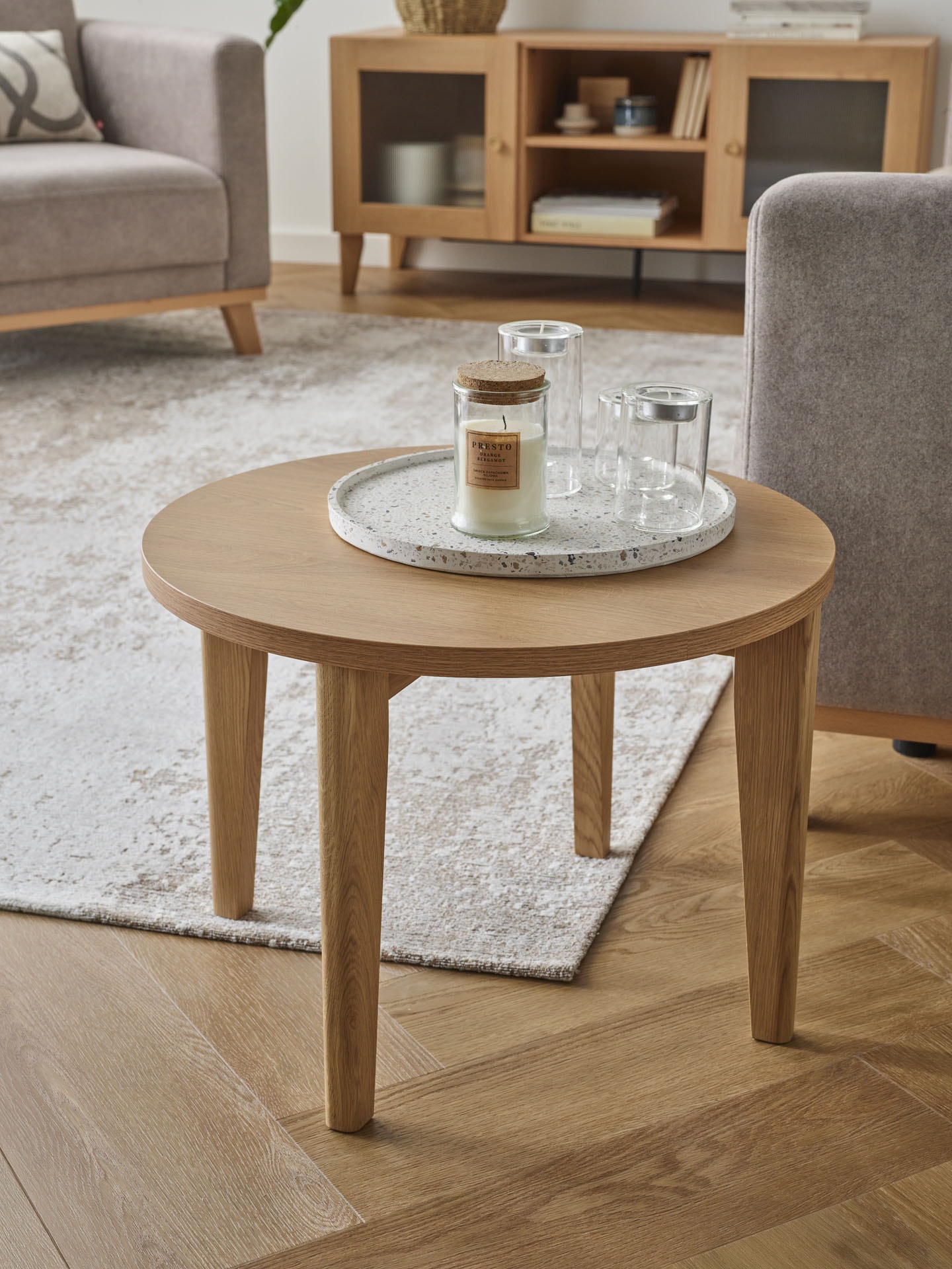 Drewniany okrągły stolik w minimalistycznym salonie